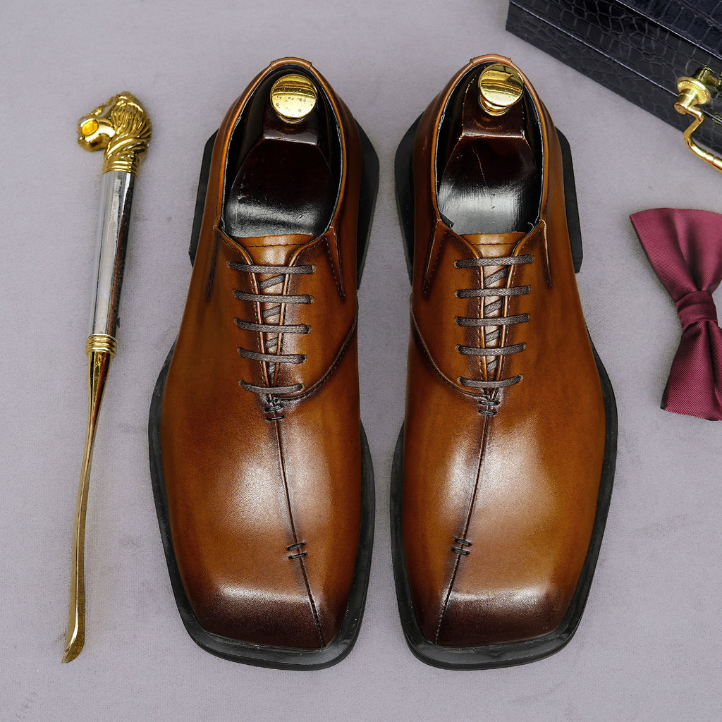 Men's chunky lug-sole wingtip brogue oxfords, tan leather look, pair front view.