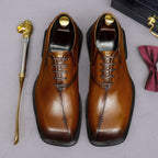 Men's chunky lug-sole wingtip brogue oxfords, tan leather look, pair front view.