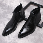 Black patterned leather side-zip ankle boots with thick soles, two-quarter view.