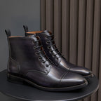 Men's dark leather lace-up ankle boots pair with stitched panels and low block heel