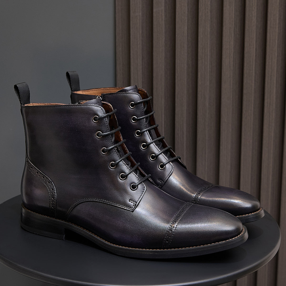 Men's dark leather lace-up ankle boots pair with stitched panels and low block heel