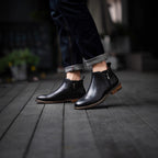 Black leather side-zip ankle dress boots with stacked heel and brown welt