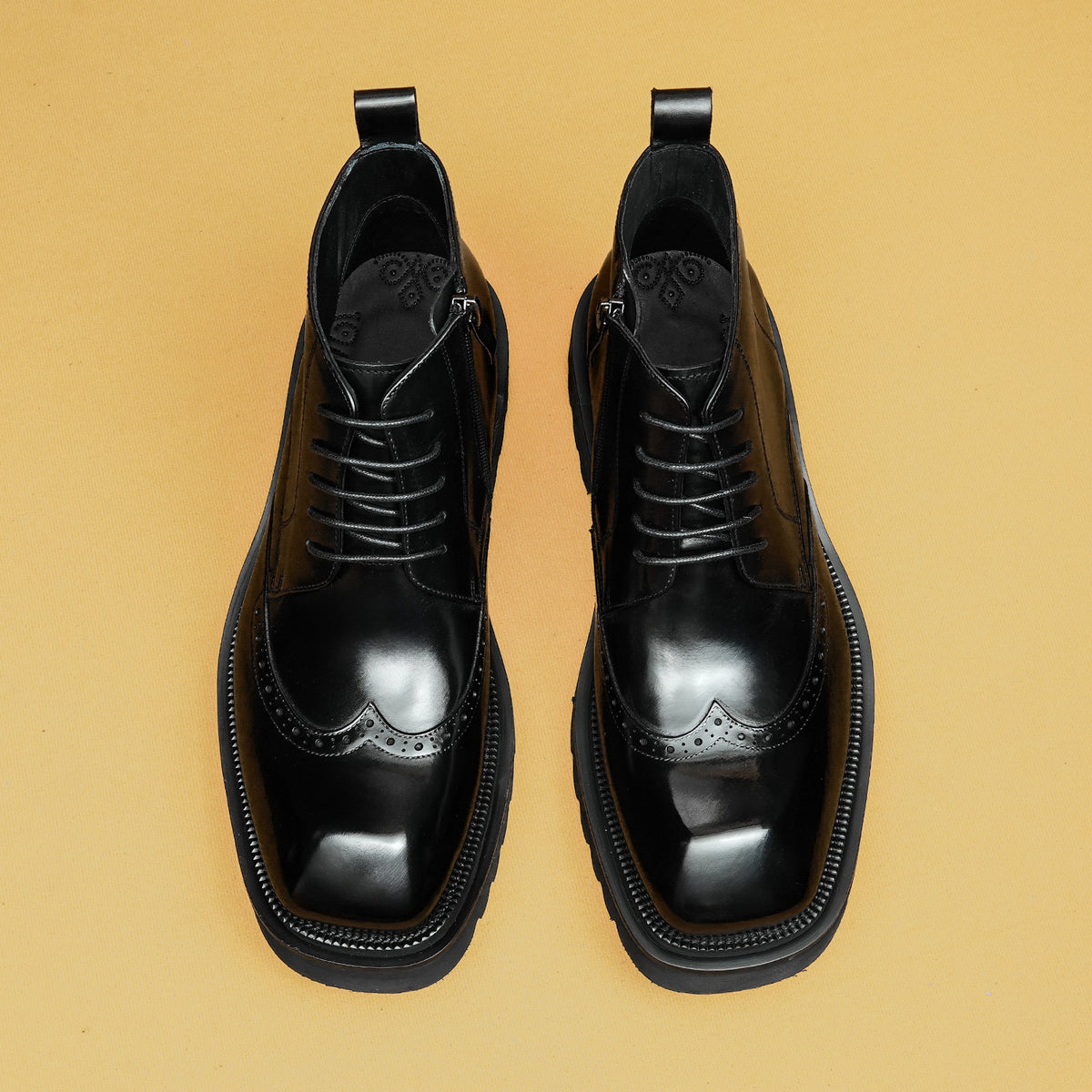 Black leather lace-up ankle boots with thick sole and pull-tab cuffs