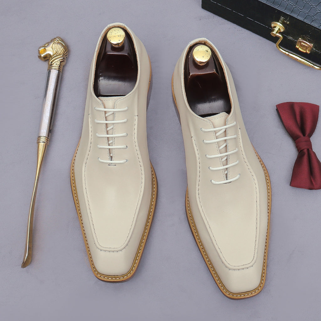 Beige chunky lug-sole brogue Oxford shoes with white laces, top-down pair view