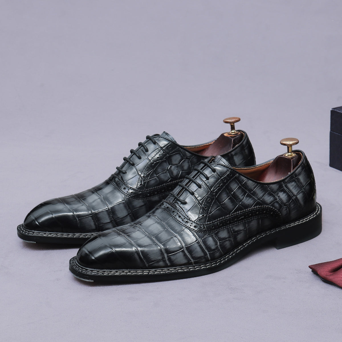 Men's black wingtip brogue oxford shoes with chunky lug sole and lace-up closure, side view