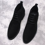 Black lace-up ankle dress boots with round toe and pull tab at heel