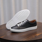 Men's genuine leather sneakers with visible outsole tread, black upper and white sole