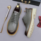 Men's pointed-toe leather derby dress shoes, gray, lace-up side view with tread sole