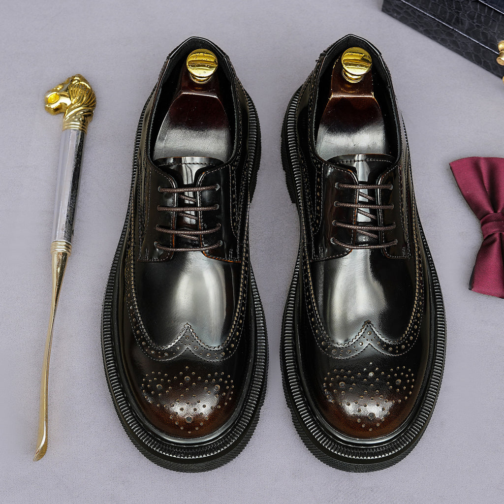 Pair of men's pointed-toe leather derby shoes, lace-up with brogue perforations and dark patina.