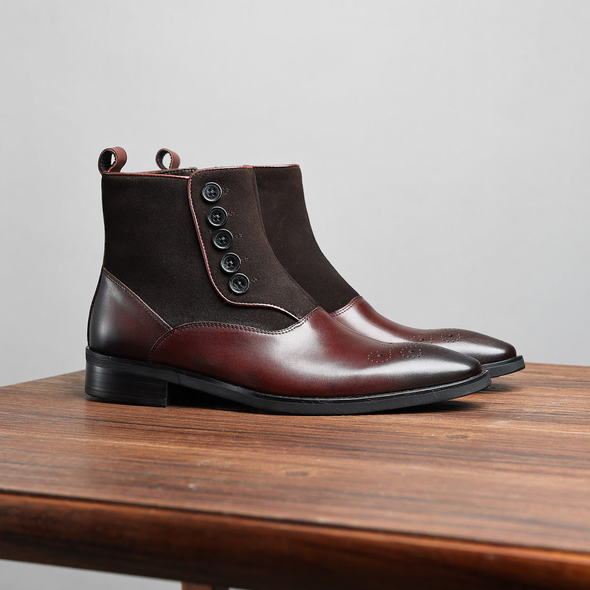 Dark brown leather ankle boots with side zip and thick sole, side profile view