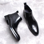 Two black leather side-zip formal boots angled view with thick sole and stitched detail