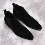 Pair of black suede Chelsea dress boots with elastic side gore and low stacked heels