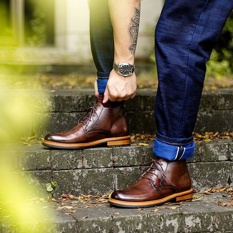 Men's brown leather chukka boots with plain toe and lace-up front, tan sole trim