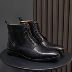 Men's pointed-cap-toe leather dress boots, black, lace-up pair side view