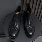 Pair of black leather side-zip pointed-toe ankle boots with stitched trim