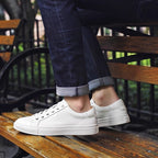 Men's white leather lace-up sneakers, side profile with low rubber sole