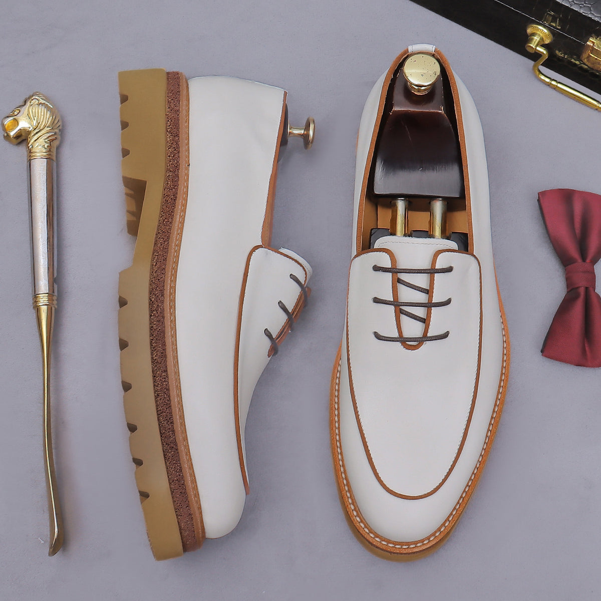 Men's chunky lug-sole oxfords in white, side profile with outsole and laces