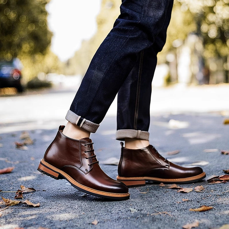 Dark brown leather lace-up chukka boots on street, plain toe and treaded outsole.