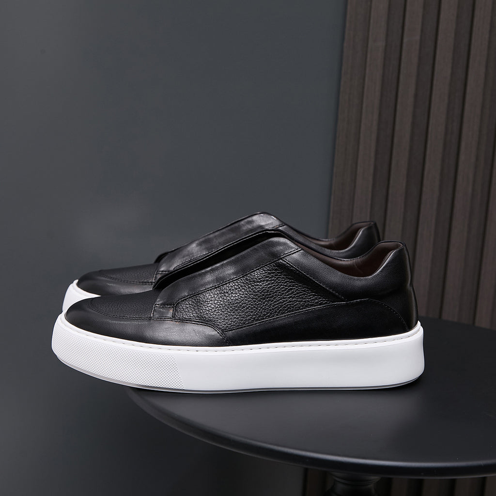 Black genuine leather low-top sneakers with minimalist side panels and white rubber sole