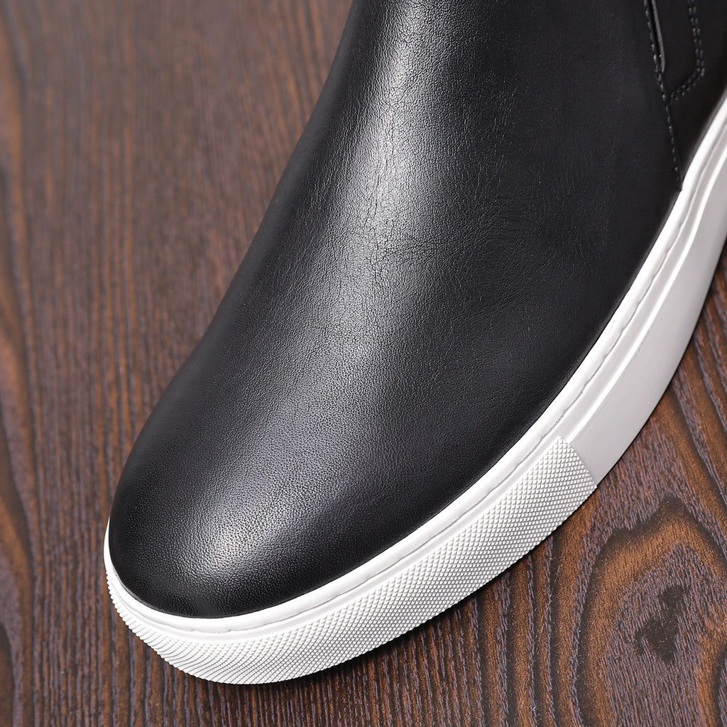 Men's point-toe leather side-zip dress boot, close-up of black leather upper and white sole
