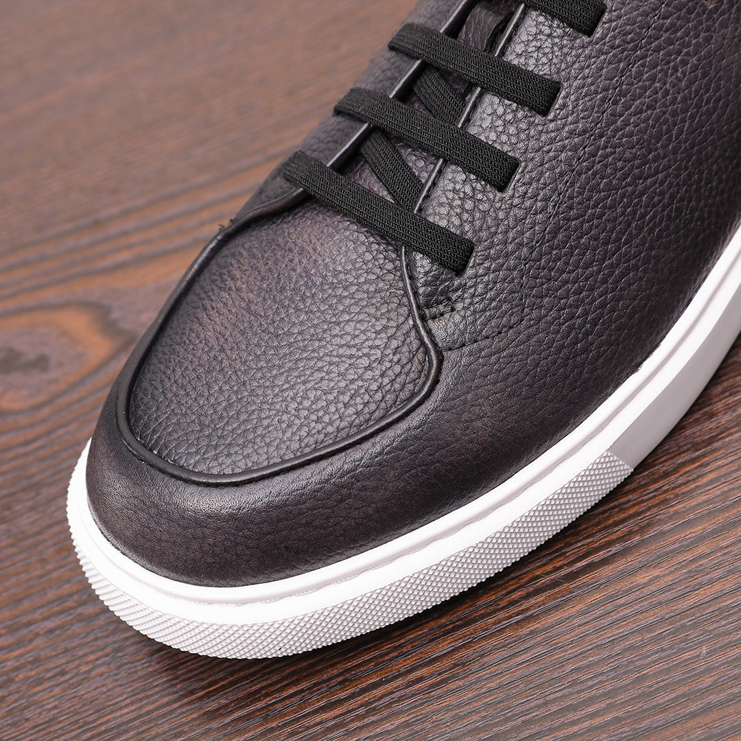 Black genuine leather sneaker with lace-up straps and rounded toe, white rubber sole.
