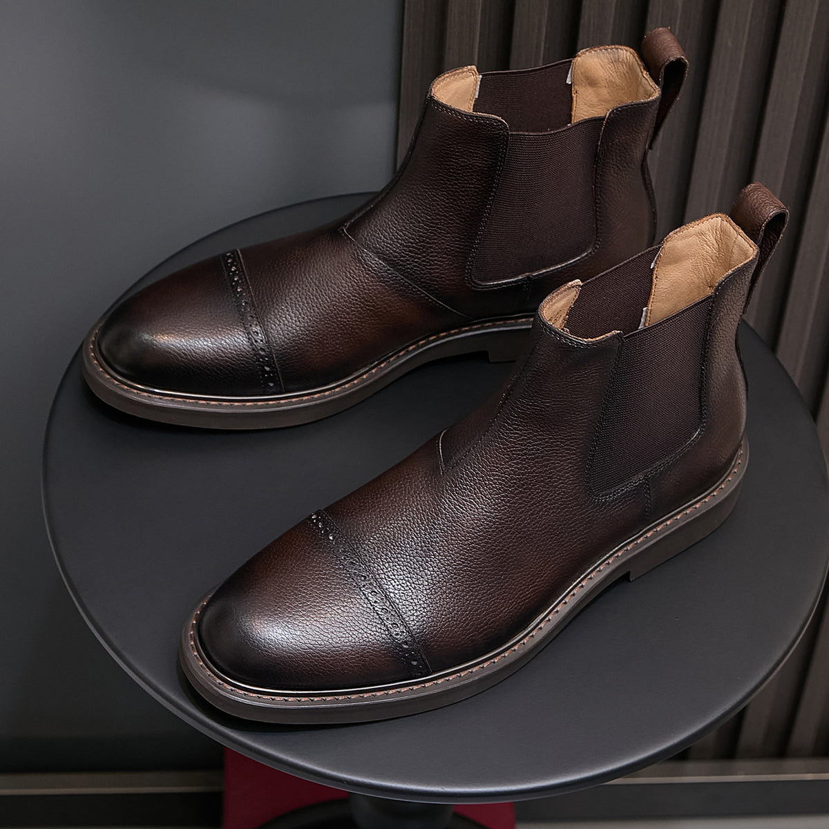 Men's dark brown Chelsea dress boots, angled side-by-side pair with elastic side panels