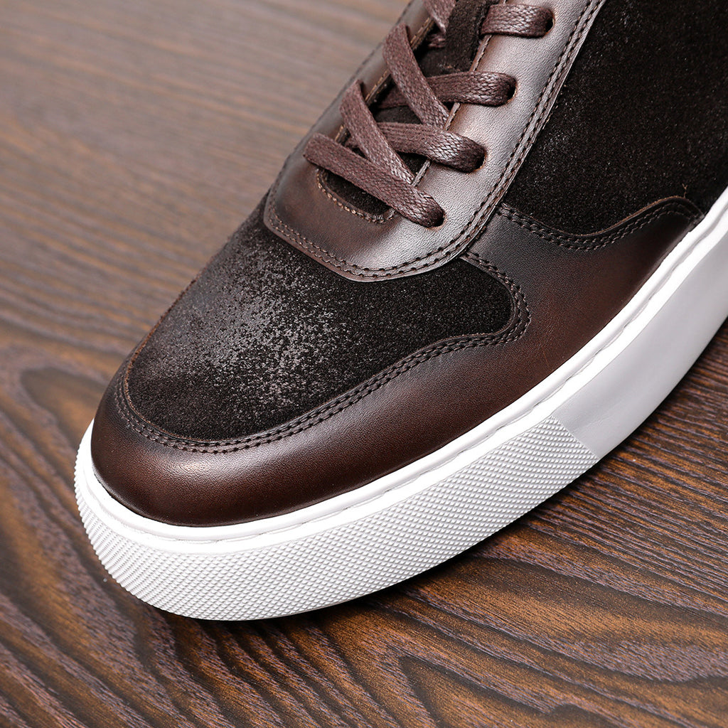 Dark brown leather sneakers close-up, lace panel and textured side with white sole