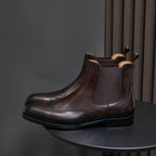 Men's pointed-toe Chelsea dress boots in dark brown, front three-quarter view