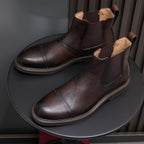 Men's pointed-toe Chelsea dress boots, dark brown side view with elastic gore and trim