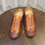 Brown leather lace-up sneakers with rounded toe, stitched overlays, cushioned interior
