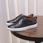 Men’s black leather sneakers with lace-up closure, perforated accents, and white sole