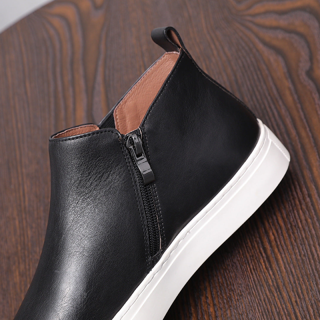Black leather side-zip dress boot with pointed toe and white rubber sole