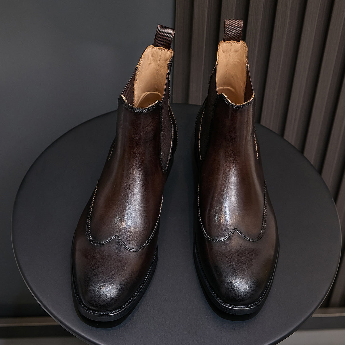Pointed-toe chelsea dress boots with elastic side panels and pull tabs, dark brown finish