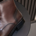 Men's pointed-cap-toe leather dress boots, dark brown, side view and stitched welt