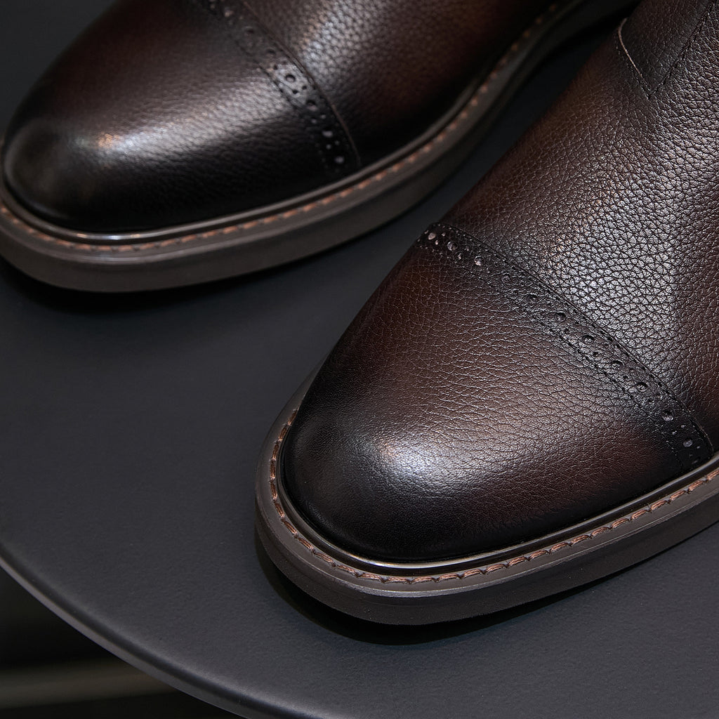 Men's dark brown Chelsea dress boots, close-up of pointed toe and side stitched detailing