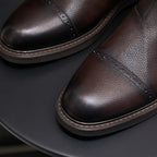 Men's dark brown Chelsea dress boots, close-up of pointed toe and side stitched detailing