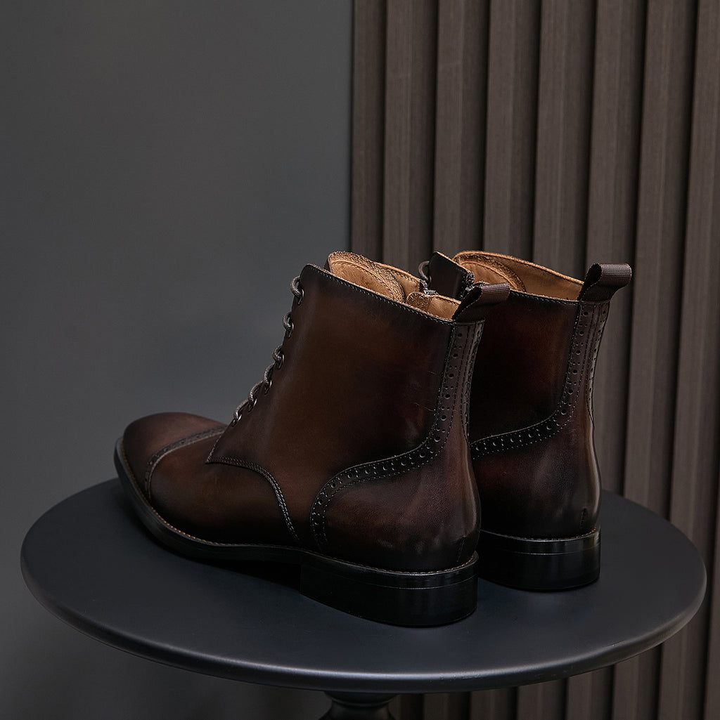 Men's pointed-cap-toe leather dress boots, dark brown pair on display