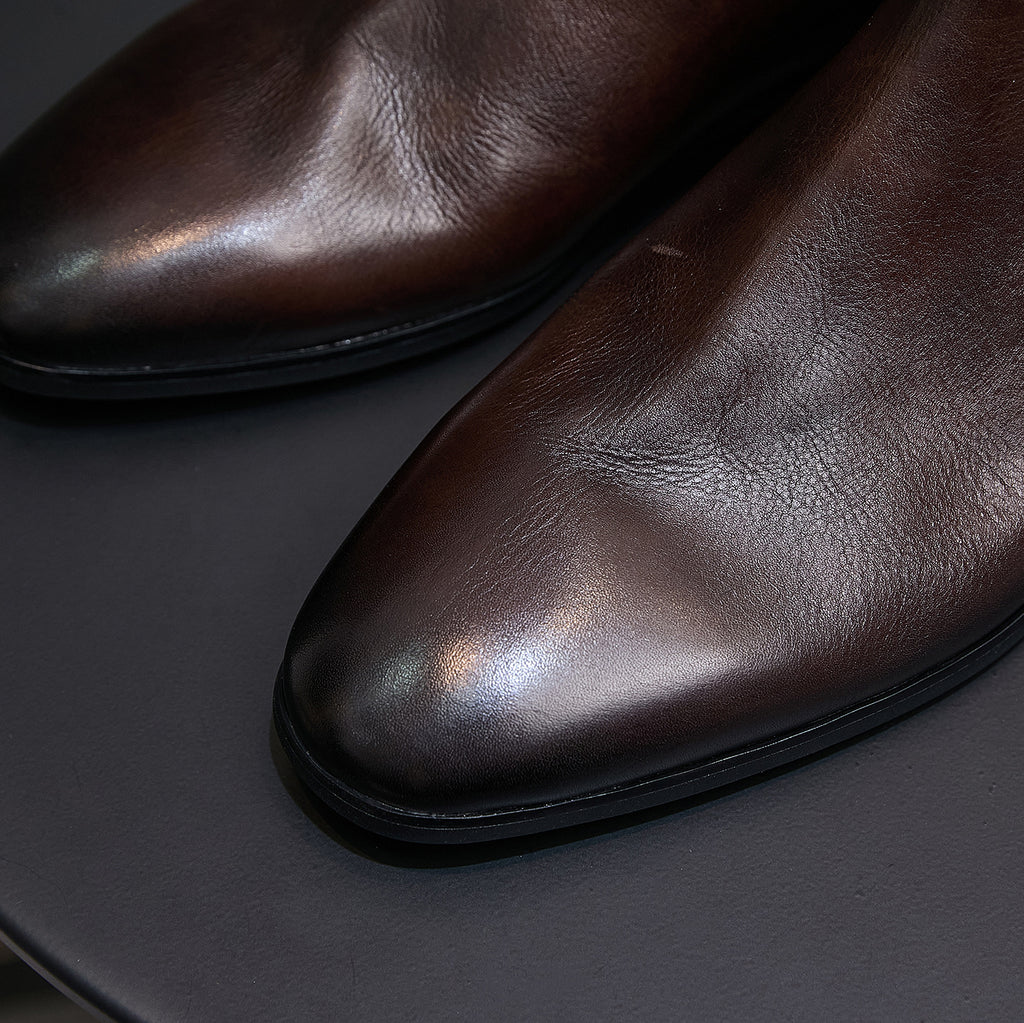 Dark brown suede Chelsea dress boots, close-up of smooth leather-like upper and sole