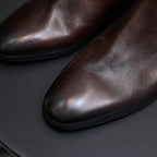 Dark brown suede Chelsea dress boots, close-up of smooth leather-like upper and sole