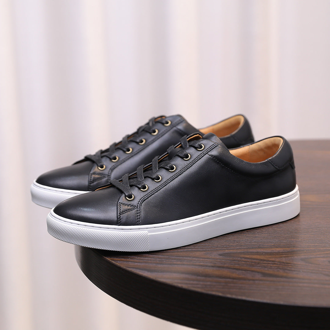Black leather low-top sneakers with white rubber outsole and lace-up front.
