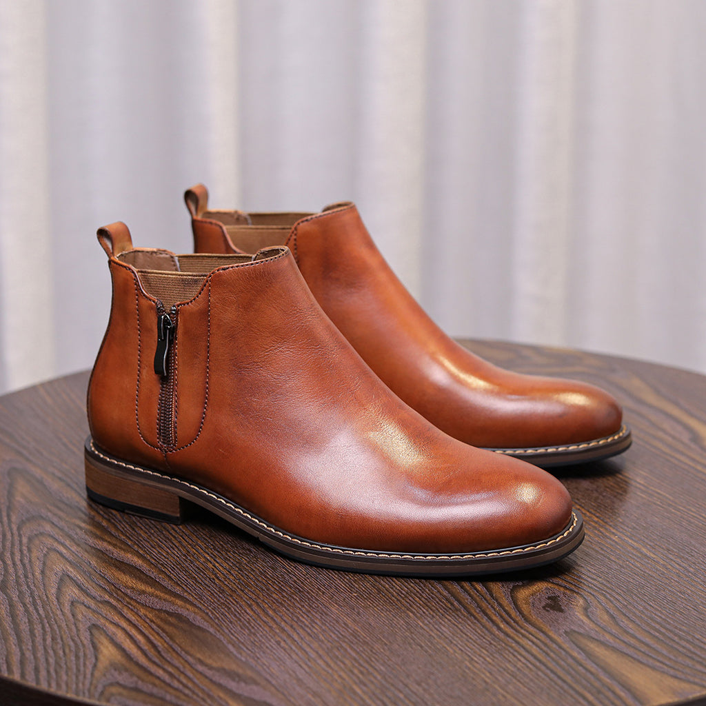 Men's brown leather side-zip dress boots on display with pointed cap toe