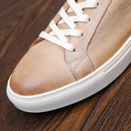 Men's leather sneakers, beige/tan, close-up of textured toe and white sole