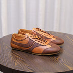 Brown leather low-top sneakers with lace-up closure, stitched quarter panels