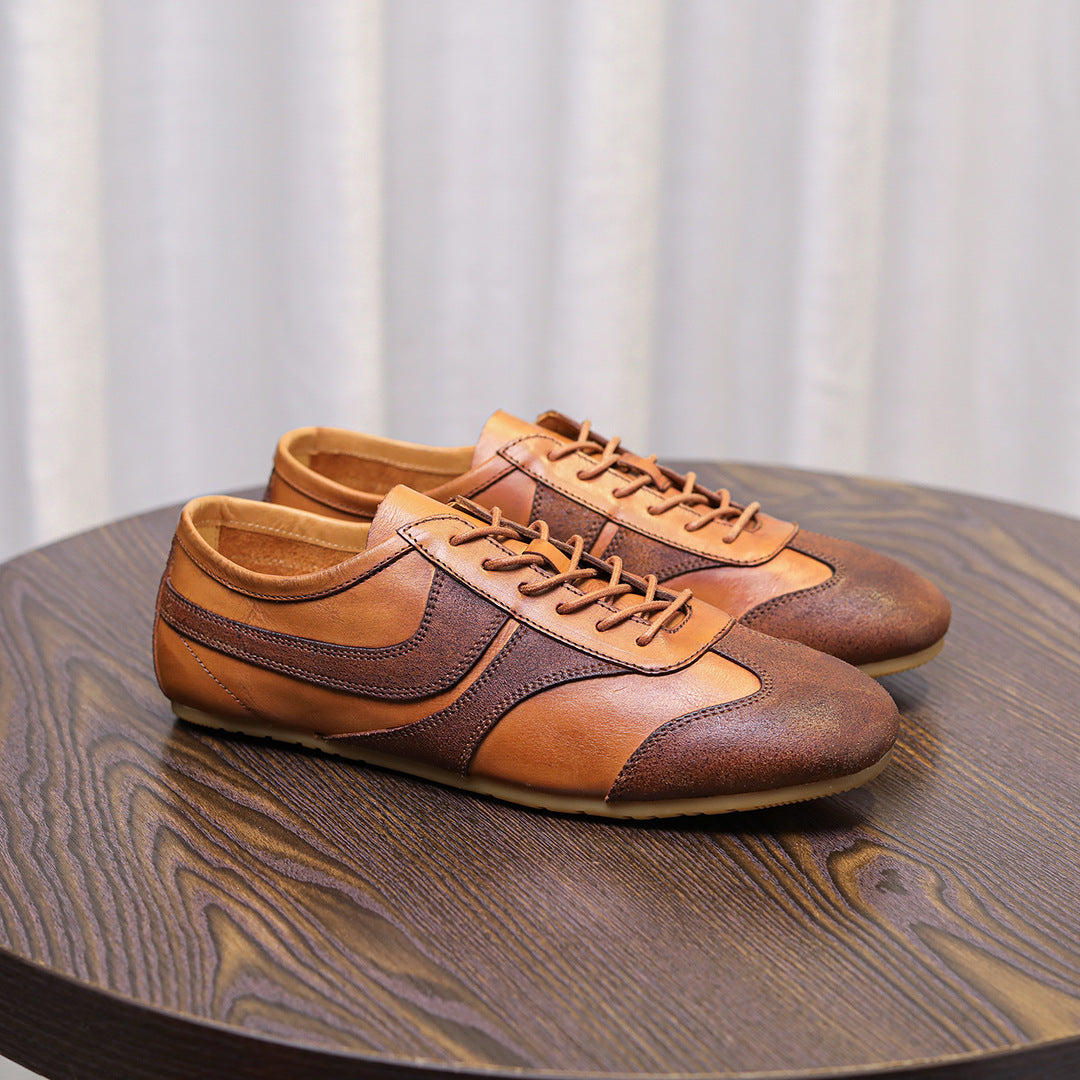 Brown leather low-top sneakers with lace-up closure, stitched quarter panels
