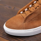 Men's brown suede lace-up sneakers with white rubber sole and textured panel