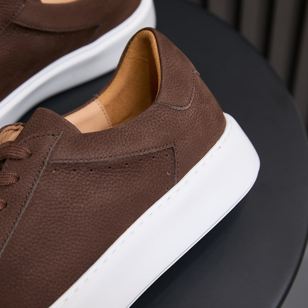 Men's brown leather sneakers side view, padded collar and white rubber sole