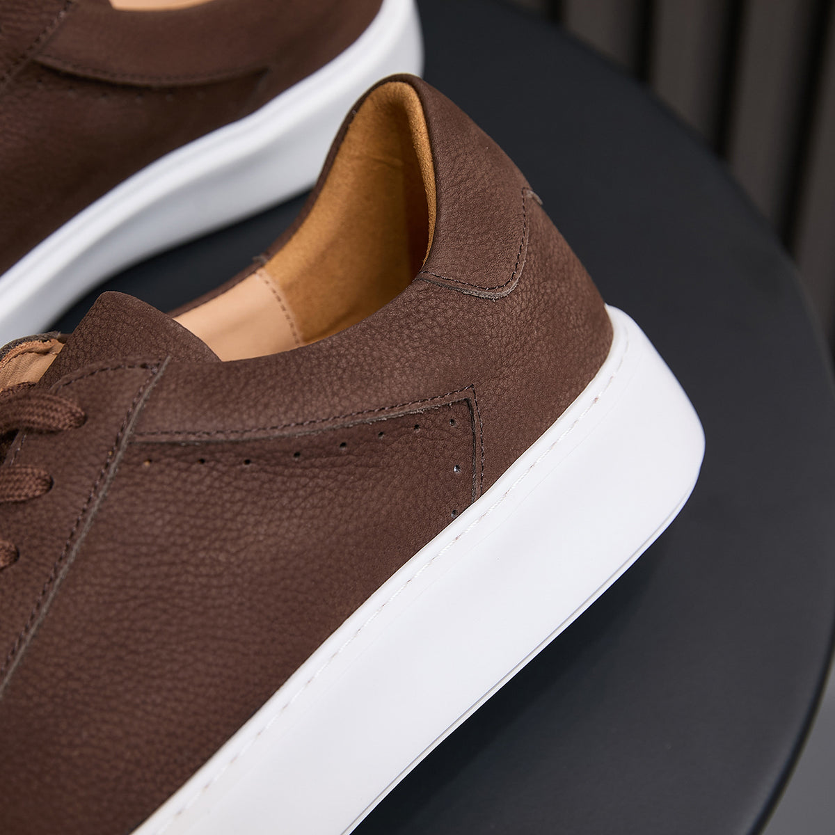 Men's brown leather sneakers side view, padded collar and white rubber sole