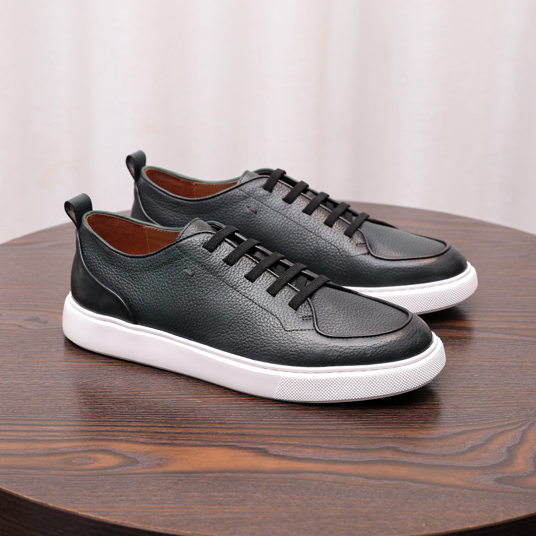 Pair of black genuine leather lace-up sneakers with white midsole and cushioned sole.