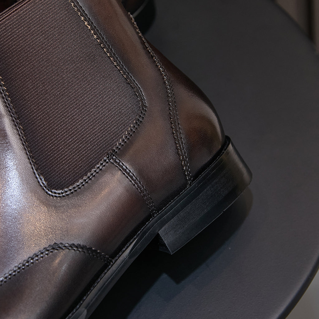 Pointed-toe chelsea boot ankle area with elastic gore and stacked low heel, dark finish