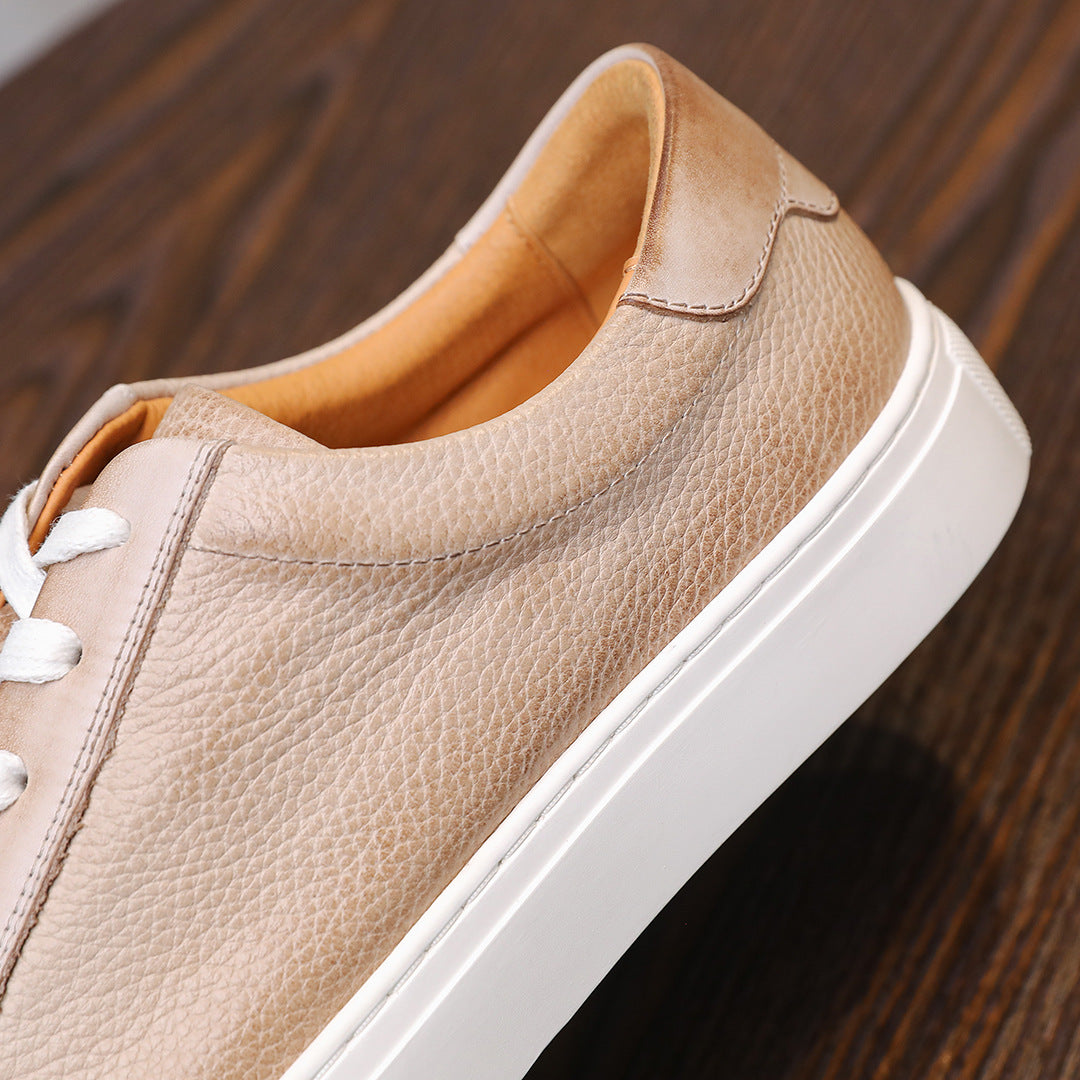 Beige leather low-top sneakers with white rubber sole and stitched side panel